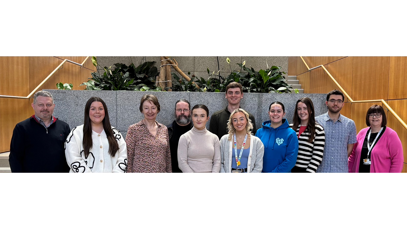 Professor Anita Maguire with a group of people smiling for photo