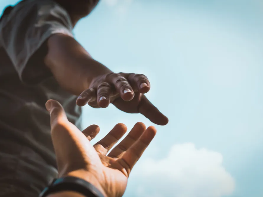 Hands reaching out to help each other