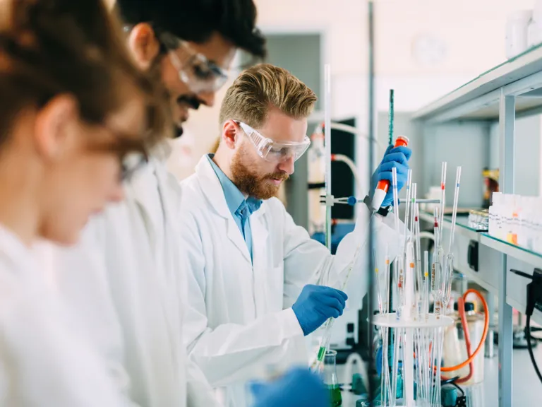 Two scientists performing experiment in a science lab