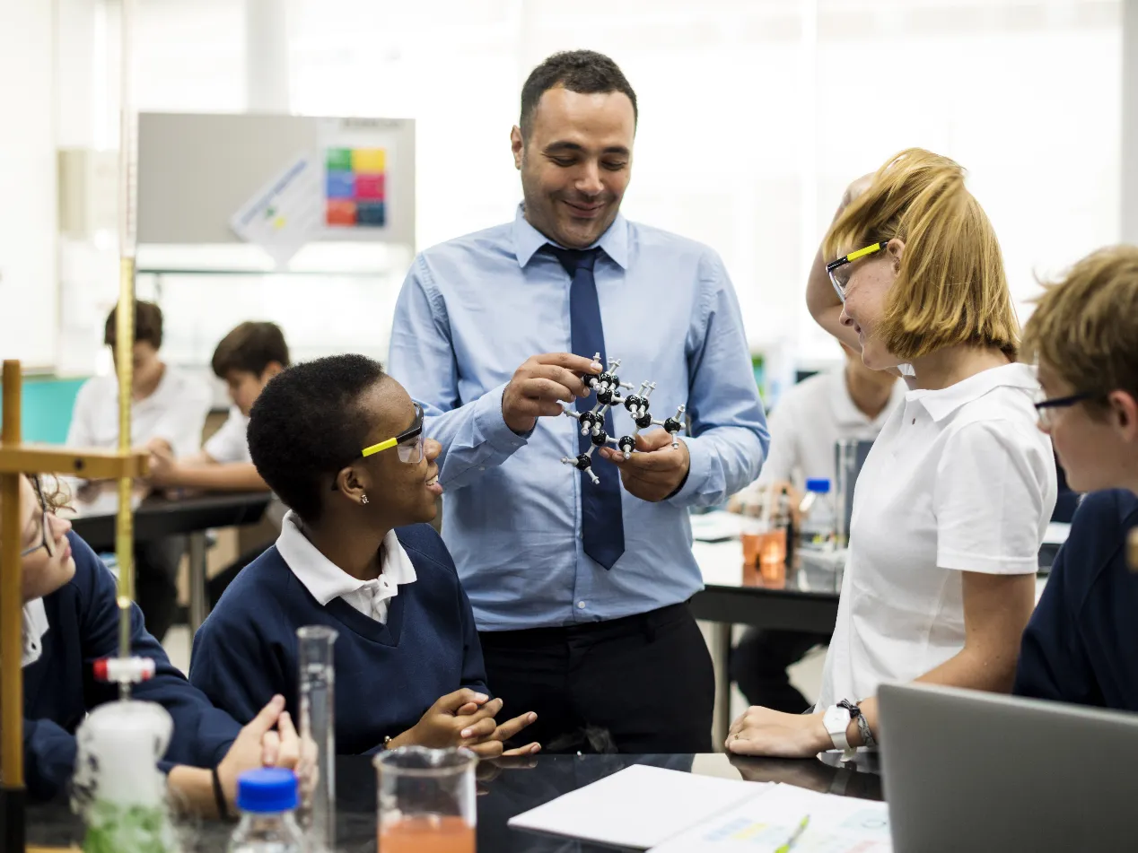 teacher with older children in classroom