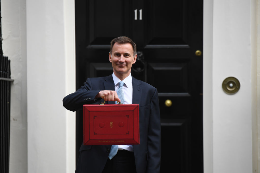Chancellor of the Exchequer Jeremy Hunt holds aloft a red Budget box outside 11 Downing Street