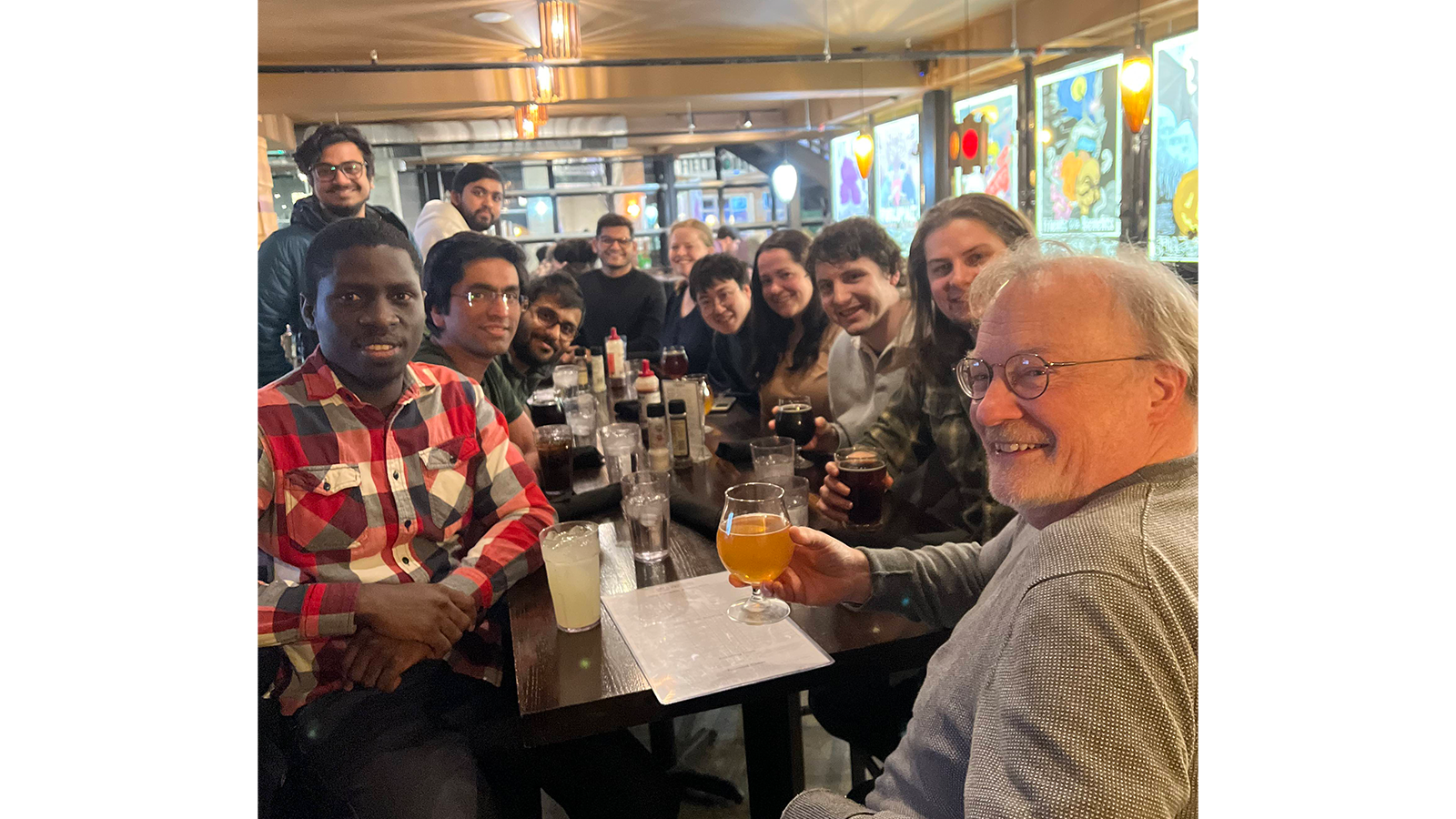 Professor James McCusker with a group of people sitting around a table