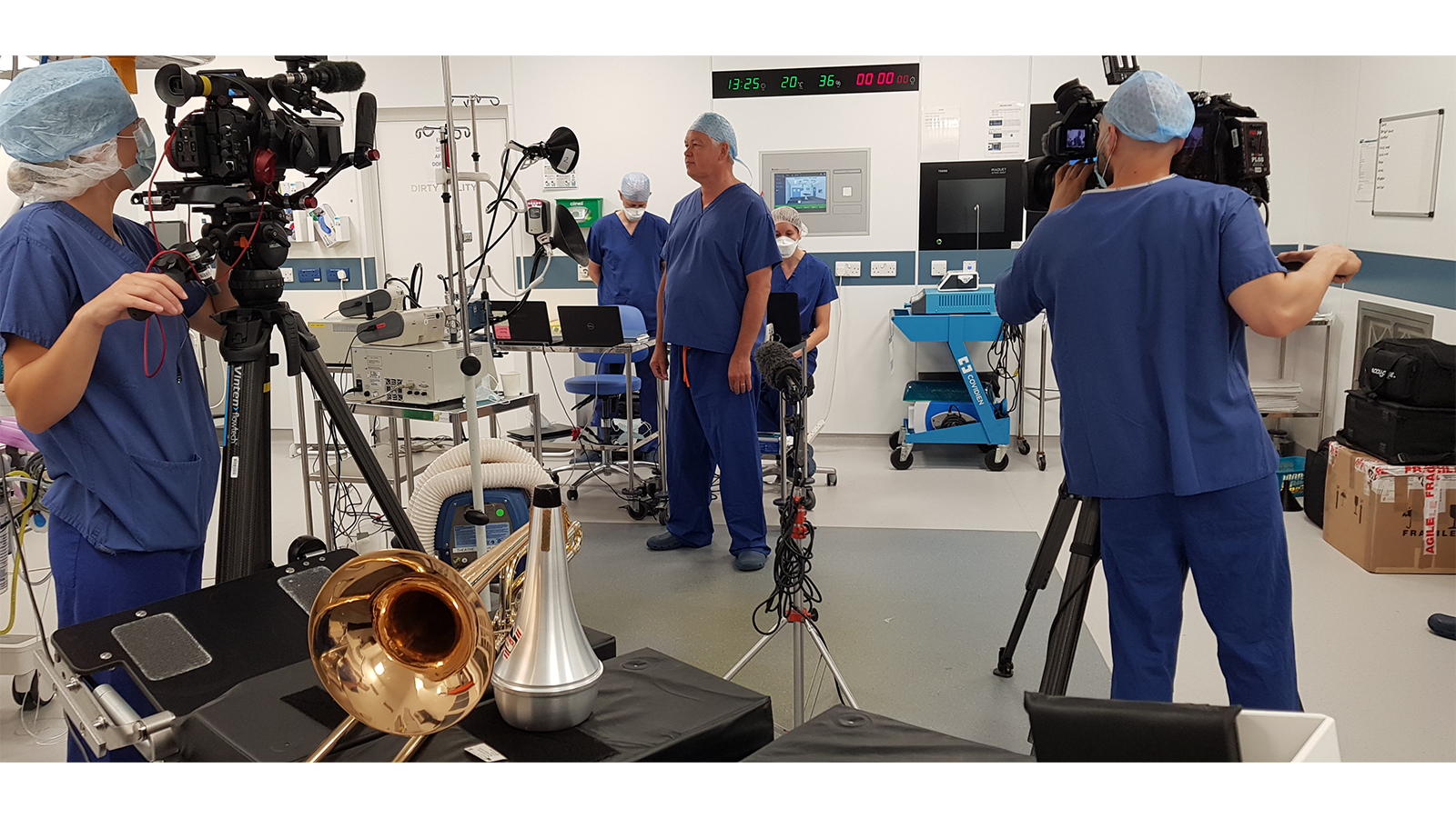 The PERFORM COVID-19 Team in scrubs in a lab with musical instruments