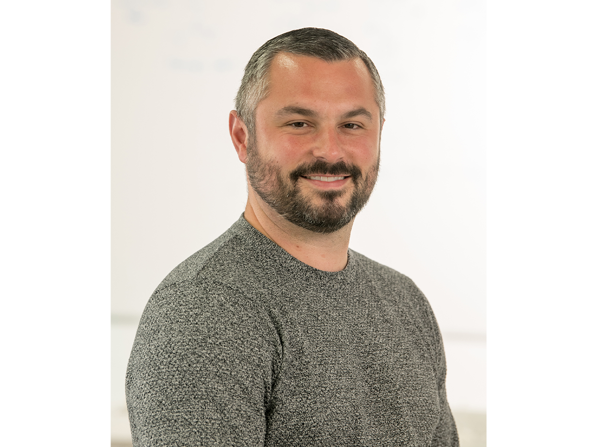 Dr Graeme Turnbull with a beard, in grey jumper