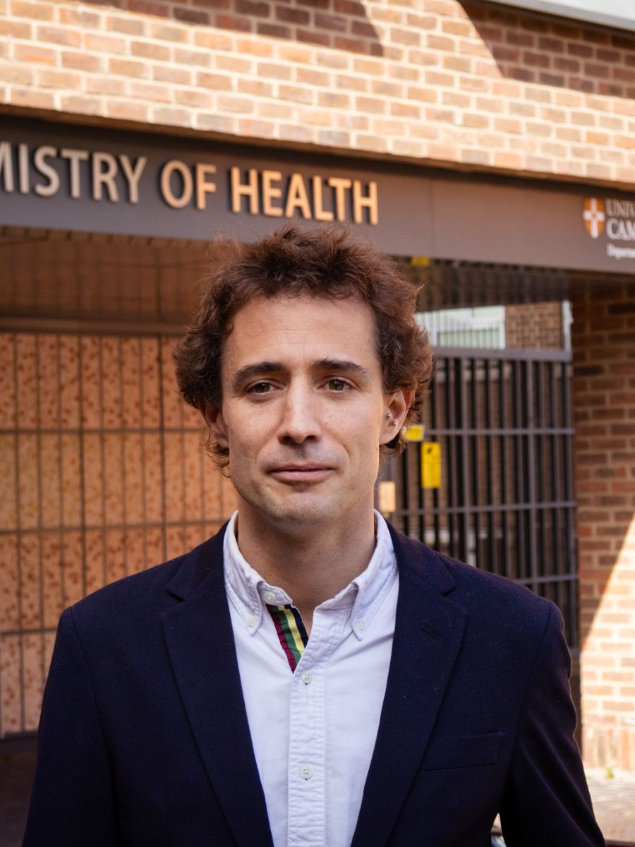 Dr Pietro Sormanni face to camera in a suit standing in front of a building