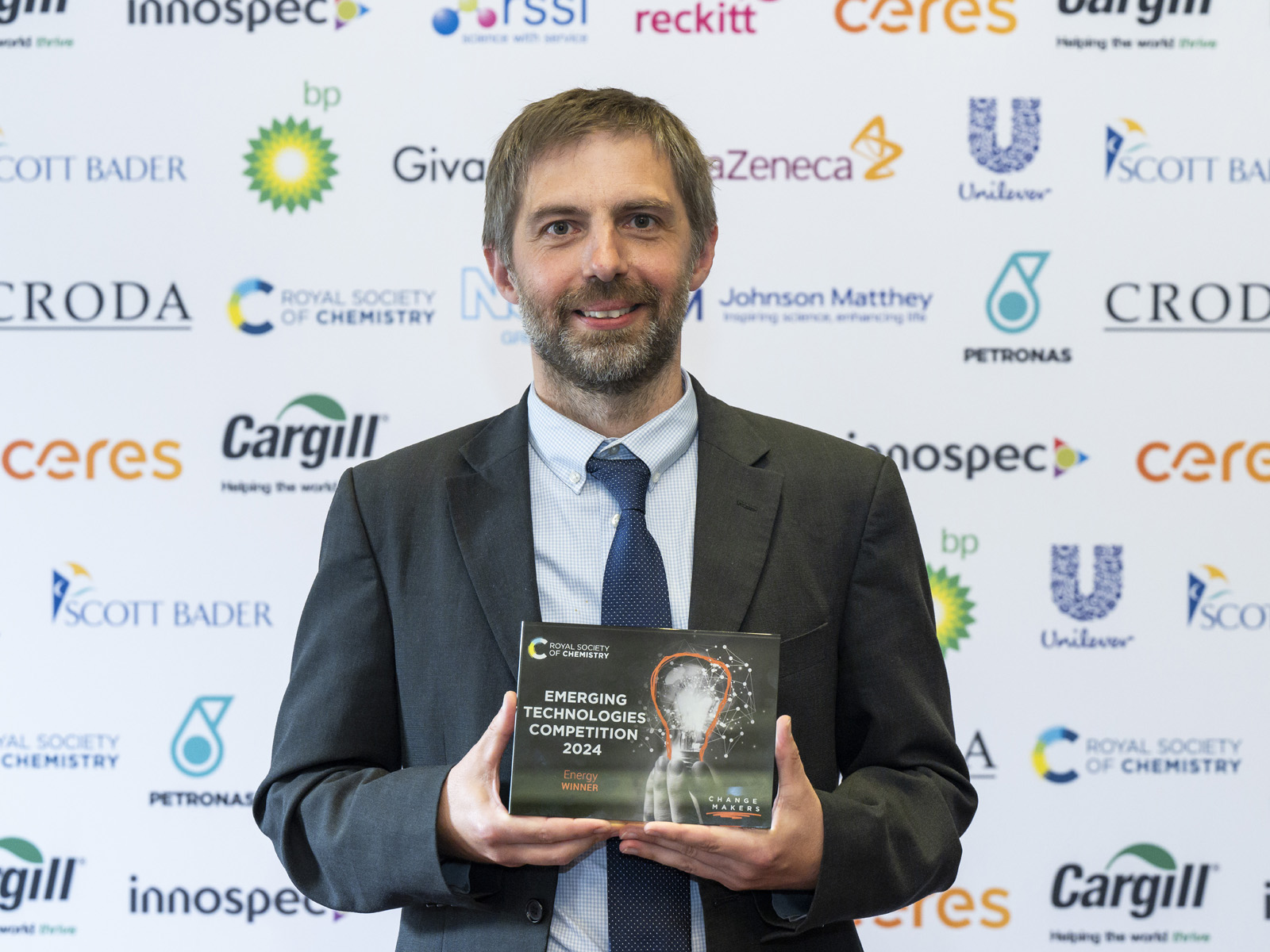Professor Stuart Scott, of the University of Cambridge, holds the trophy after H2Upgrade won the 2024 Energy award