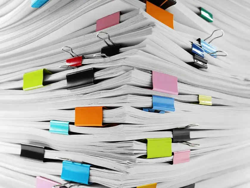 a stack of papers with binders