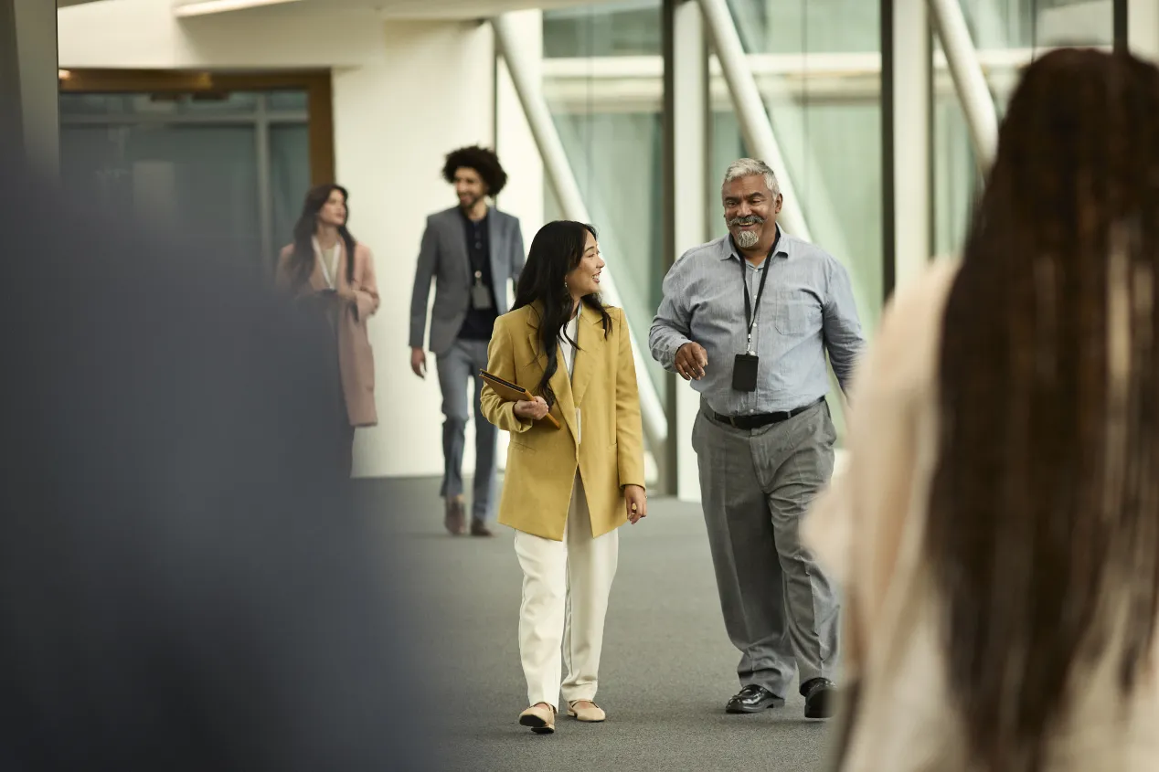 man and woman talking in hallway