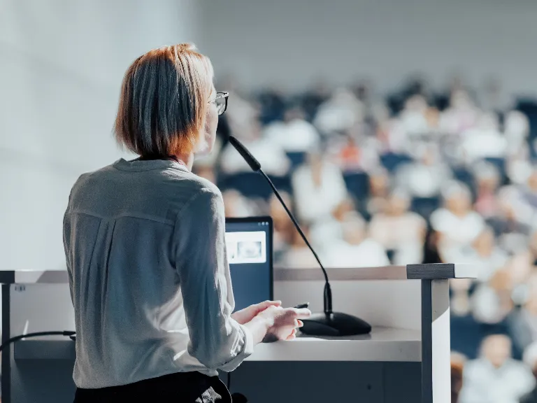 woman giving a lecture at a conference