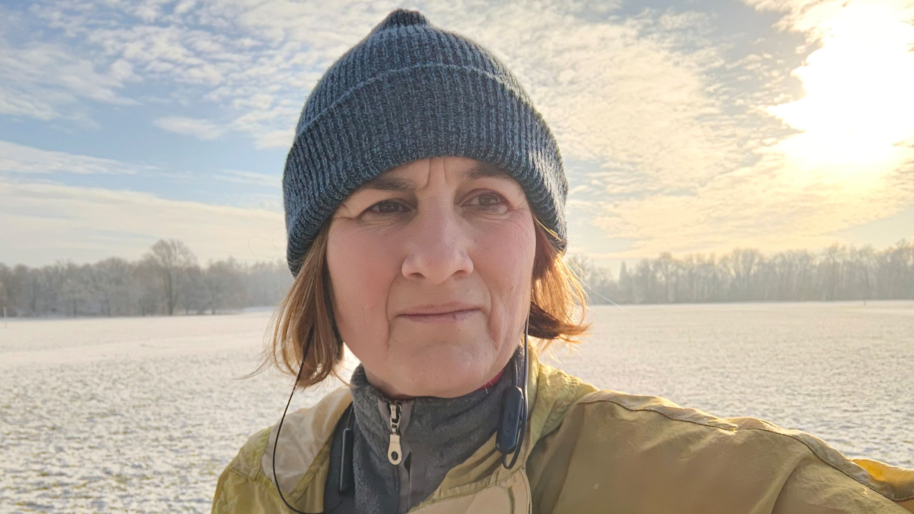 Professor Perdita Barran wearing wool hat and warm clothes, taking a selfie in a snowy field