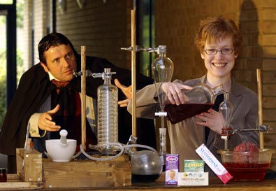 Actor Neal Upton and Kathryn Lees with Victorian chemical equipment and modern products