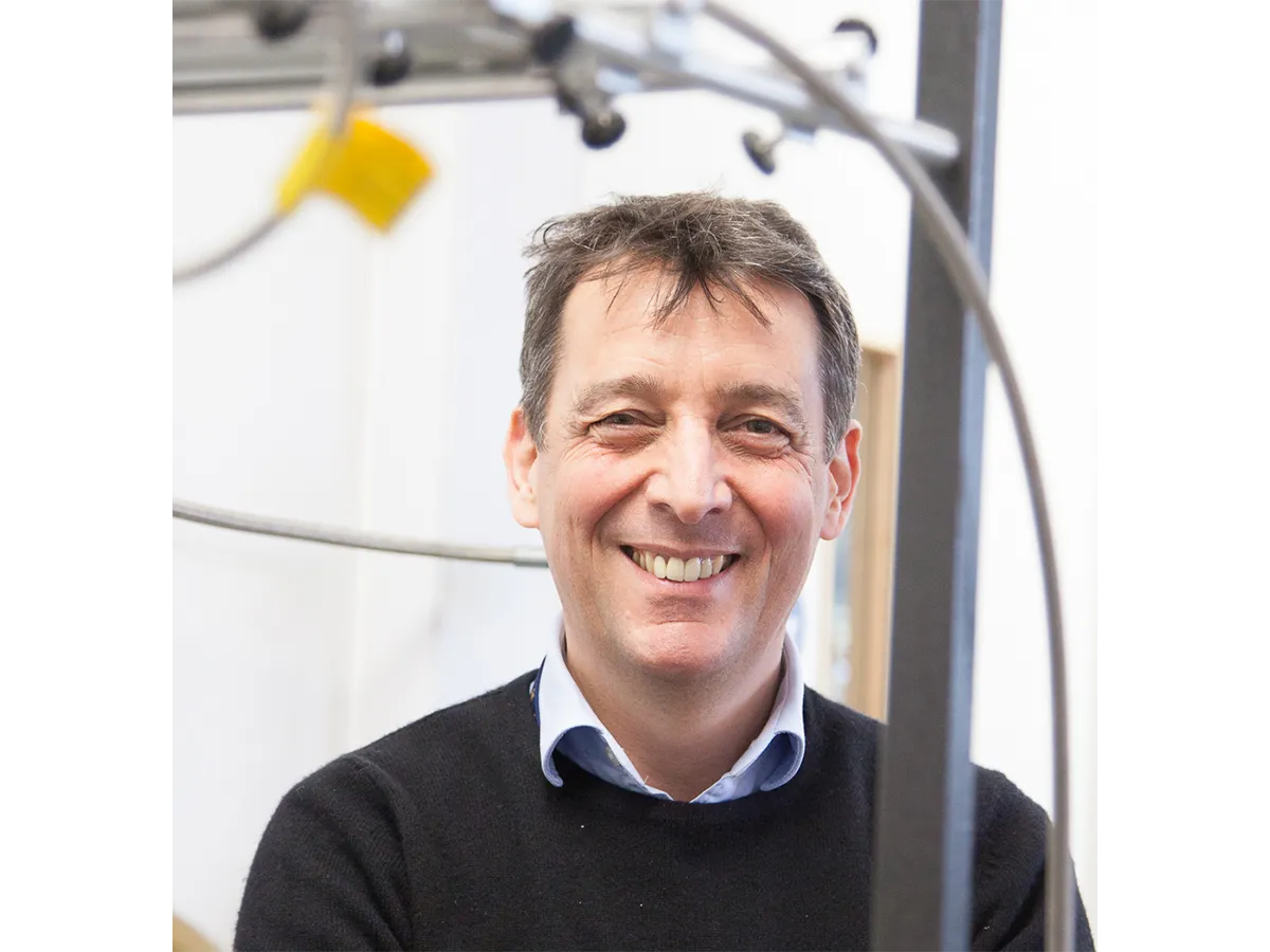 Professor Paul Walton headshot, smiling in open necked shirt and jumper