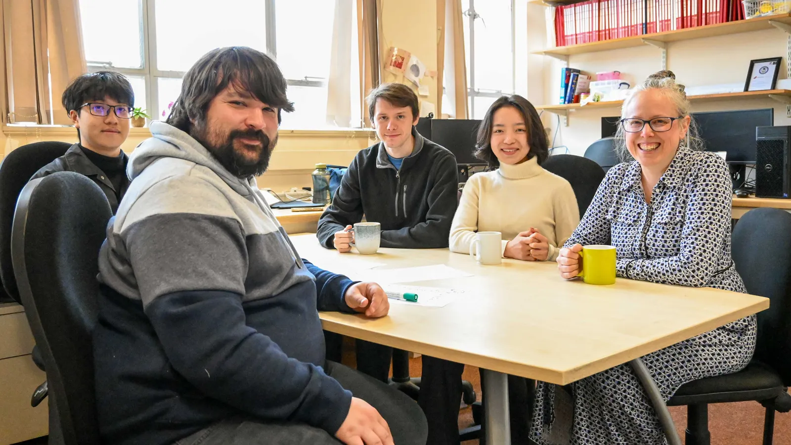 Biocatalytic Nitro Hydrogenations team members sitting at a table, smiling to camera