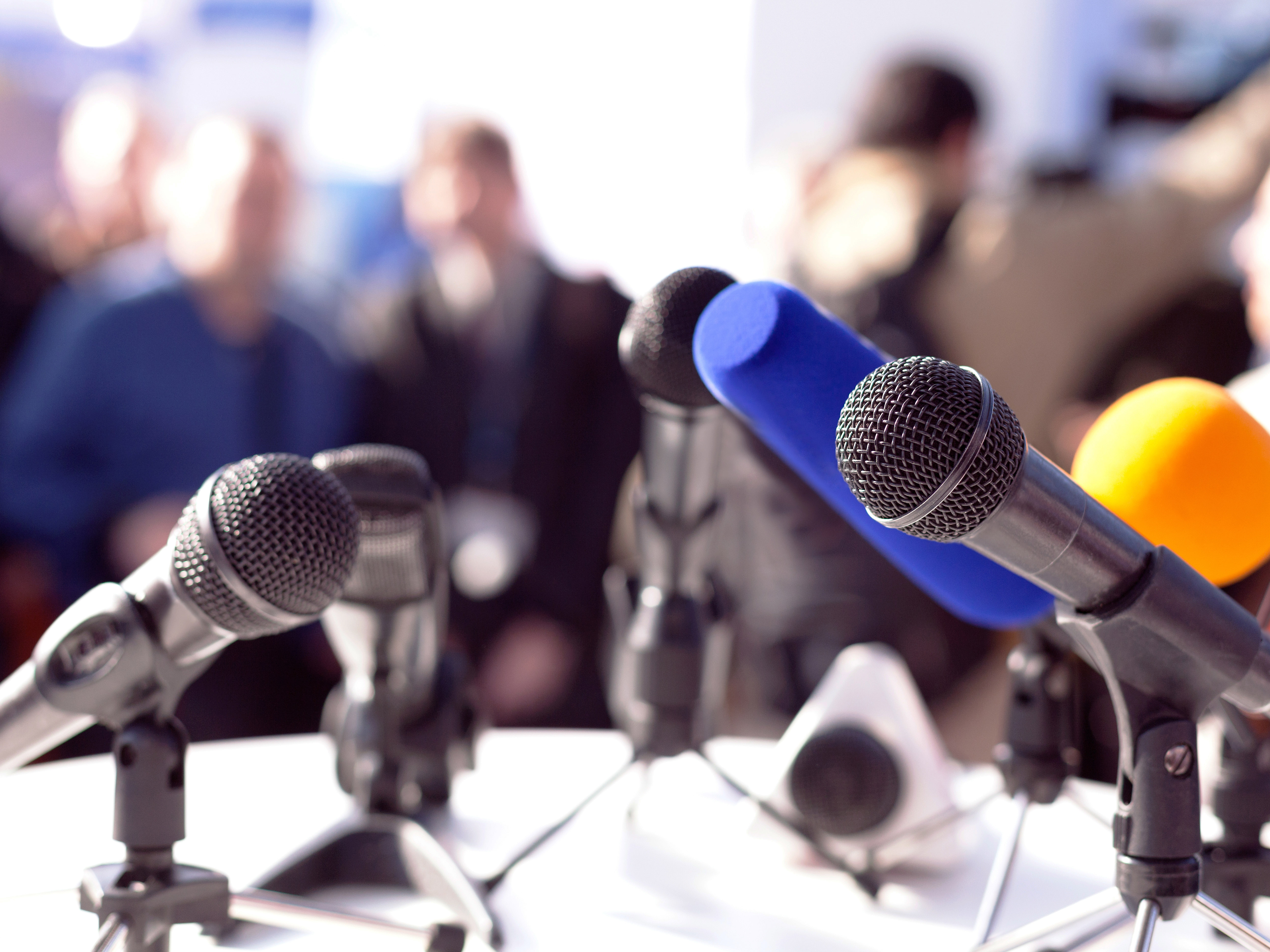 microphones on a table at a conference