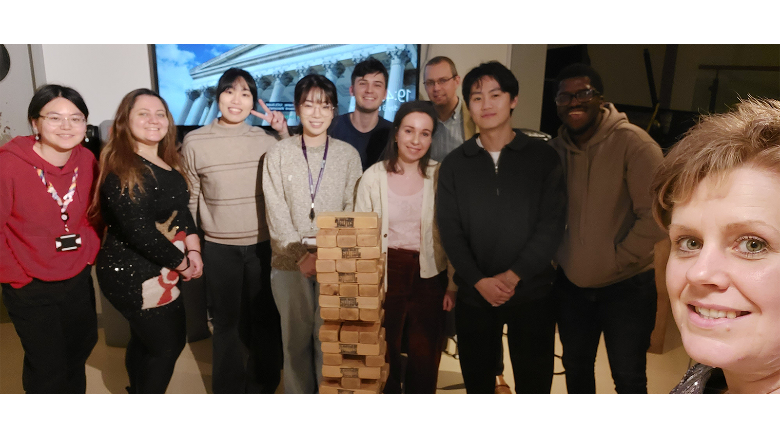 Zoe with colleagues playing wooden jenga