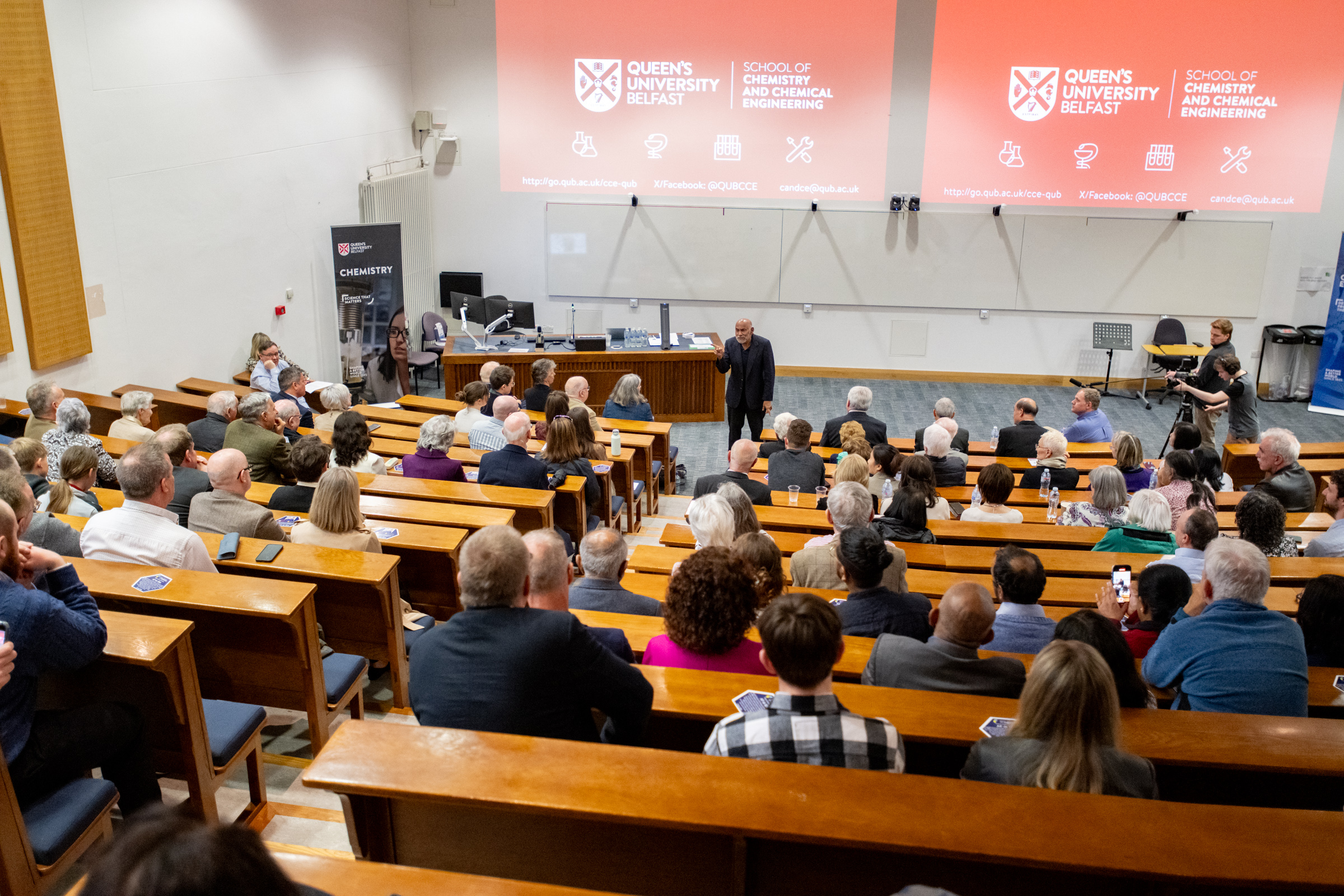 Hundreds of people watch Prof AP de Silva give a speech in a lecture hall at Queen's University Belfast after the unveiling Hundreds of people watch Prof AP de Silva give a speech in a lecture hall at Queen's University Belfast after the unveiling