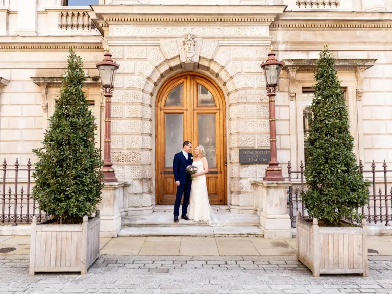 Newly married couple outside RSC Burlington House front door