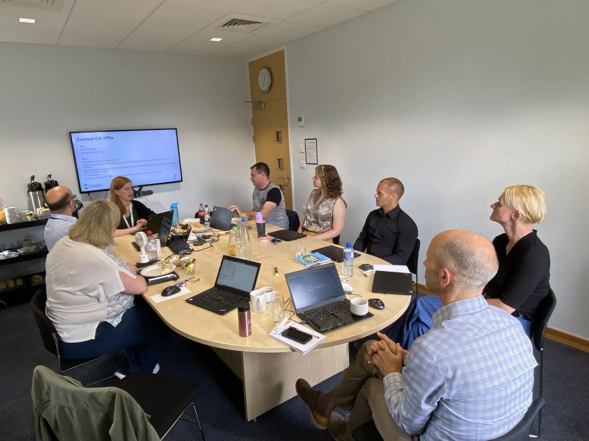 The Royal Society of Chemistry Open Access group sits around a wooden table to Thomas Graham House in Cambridge