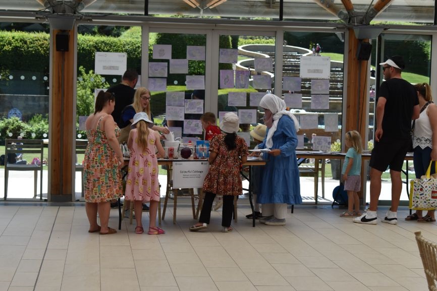 Families gather at an activity table at the Poison Garden at Alnwick Garden Families gather at an activity table at the Poison Garden at Alnwick Garden