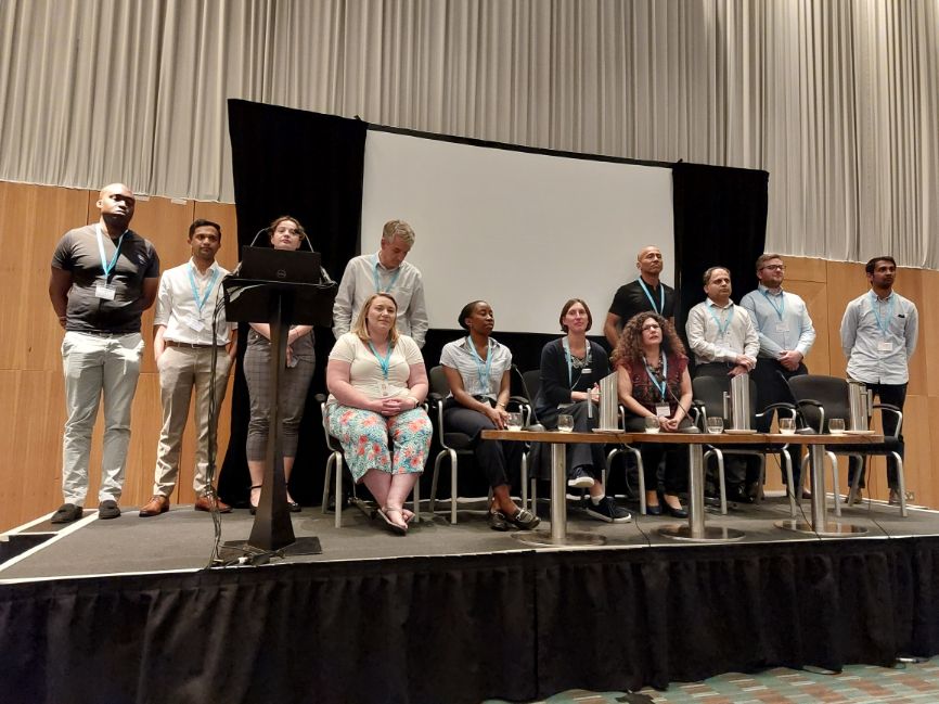 Representatives from each of the 11 partner companies on stage after the flash presentations