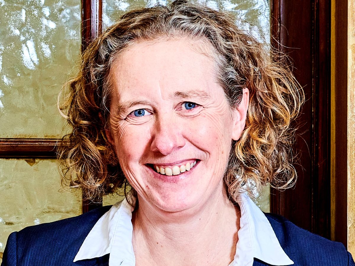 A picture of Professor Candy Rowe smiling in front of a wooden door with glass panels A picture of Professor Candy Rowe smiling in front of a wooden door with glass panels