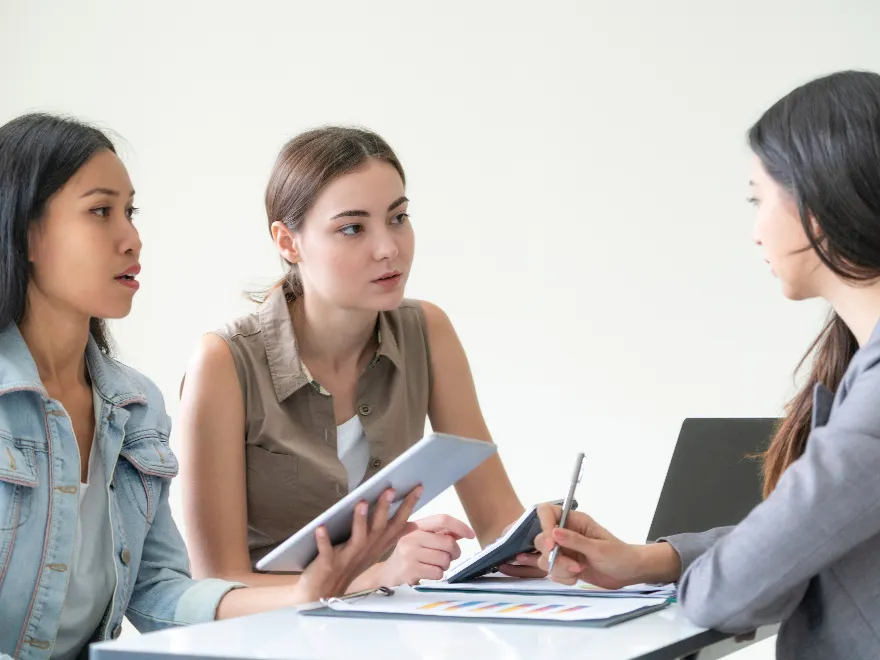 A group of women discuss in meeting at the office