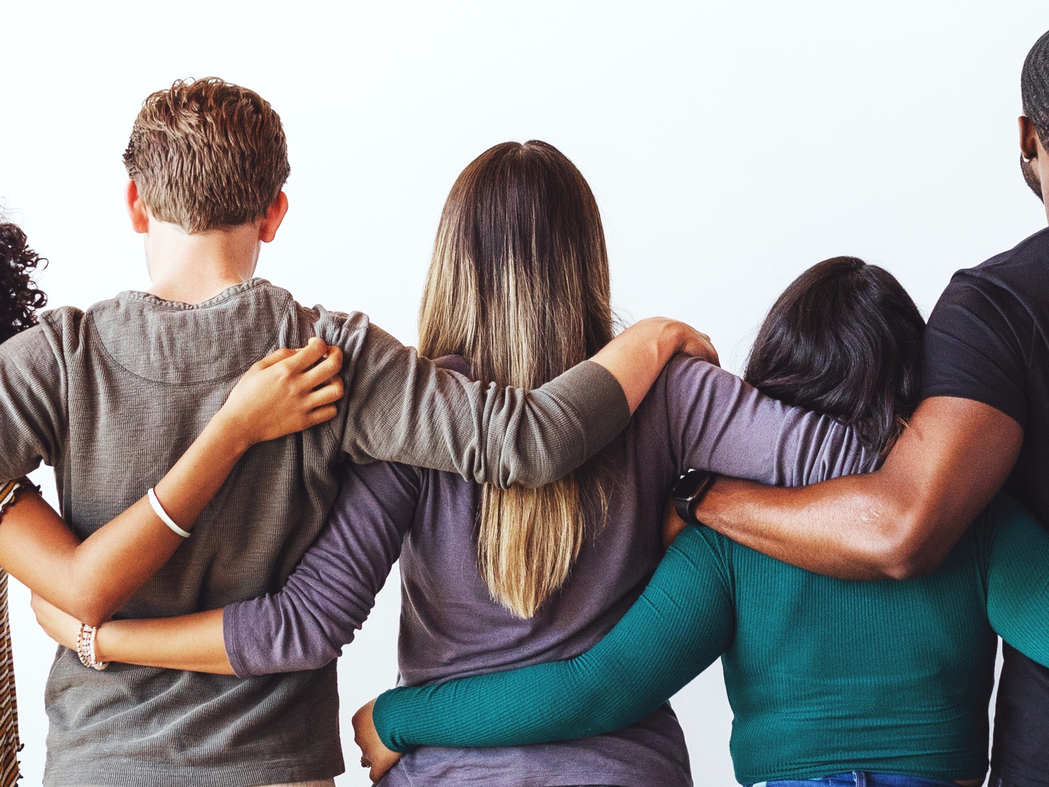 People in a row with arms around each others shoulders