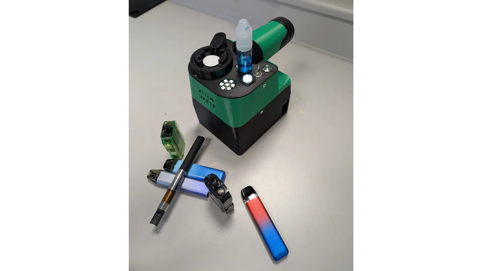A green and black drug detecting device created by Harm Reduction