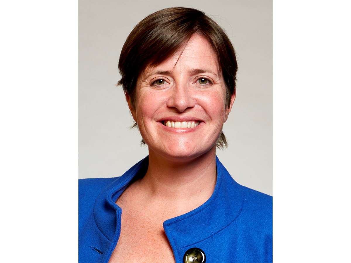 Professor Rachel O’Reilly in a blue jacket smiling for the camera