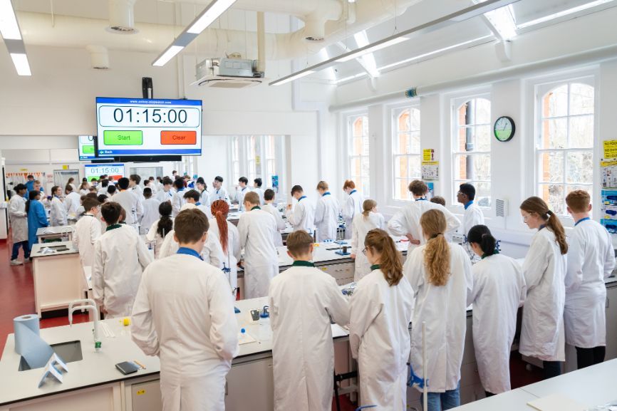 Students stand in a lab as part of the Top of the Bench final activities
