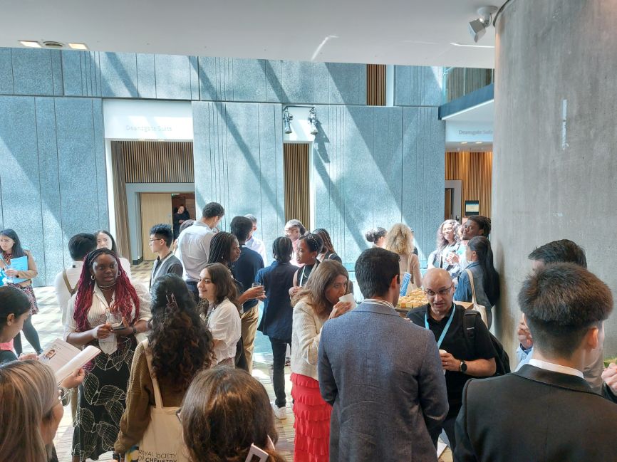 People mingle and talk in a bright open space