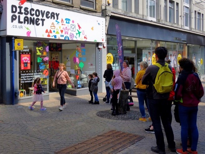 Children and adults standing outside the latest science workshops opening at Discovery Plant 