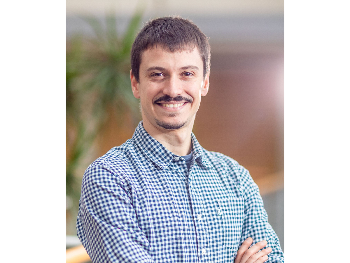 a man with a mustache smiling