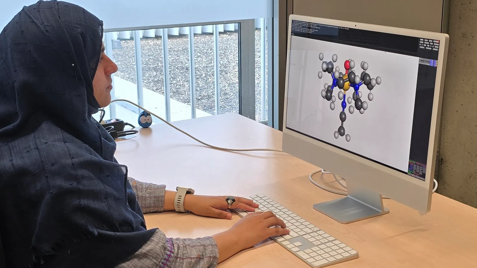 Nonheme iron-oxo oxidants team member sitting at a desk using a computer for their analysis