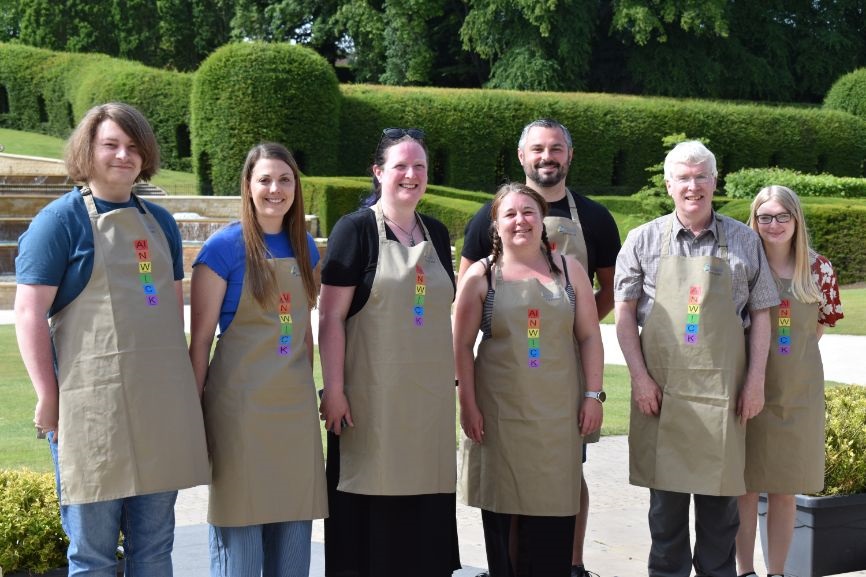 The volunteer team behind the event wearing specially designed chemistry aprons The volunteer team behind the event wearing specially designed chemistry aprons