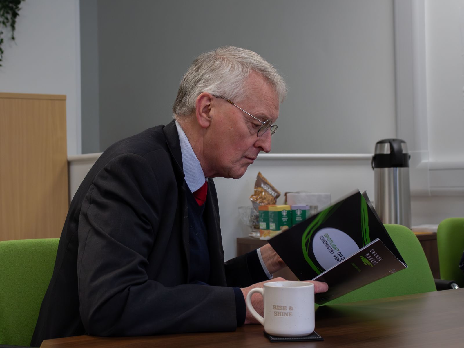 Hilary Benn MP reads a Change Makers brochure