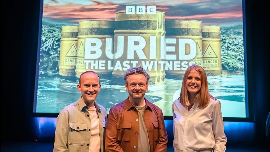 Actor and campaigner Michael Sheen (centre) with investigative reporters Dan Ashby and Lucy Taylor stand in front of a screen that has the logo for the 'Buried: The Last Witness' series Actor and campaigner Michael Sheen (centre) with investigative reporters Dan Ashby and Lucy Taylor stand in front of a screen that has the logo for the 'Buried: The Last Witness' series