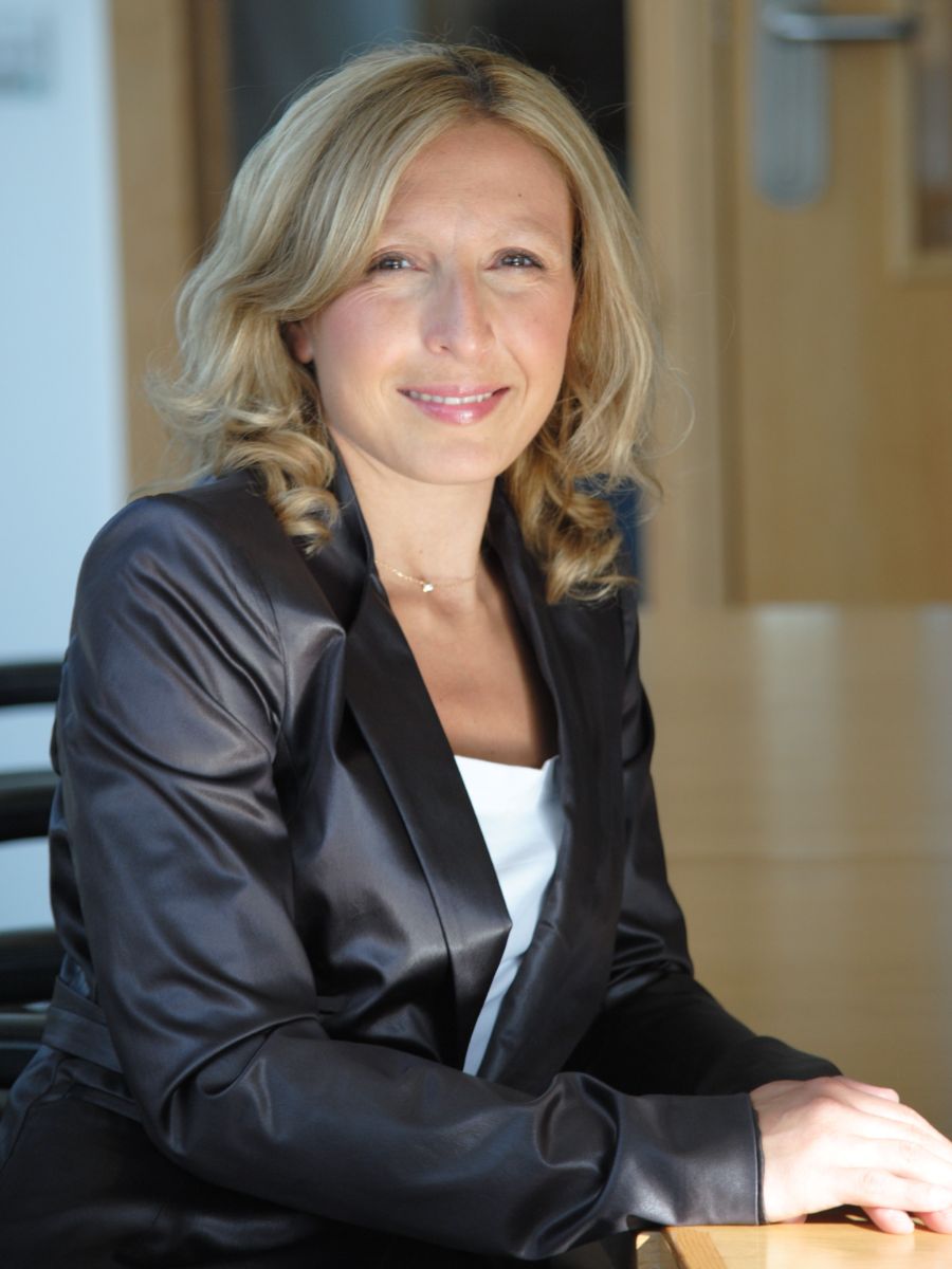 Professor Valeria Nicolosi smiling for camera in silk black jacket