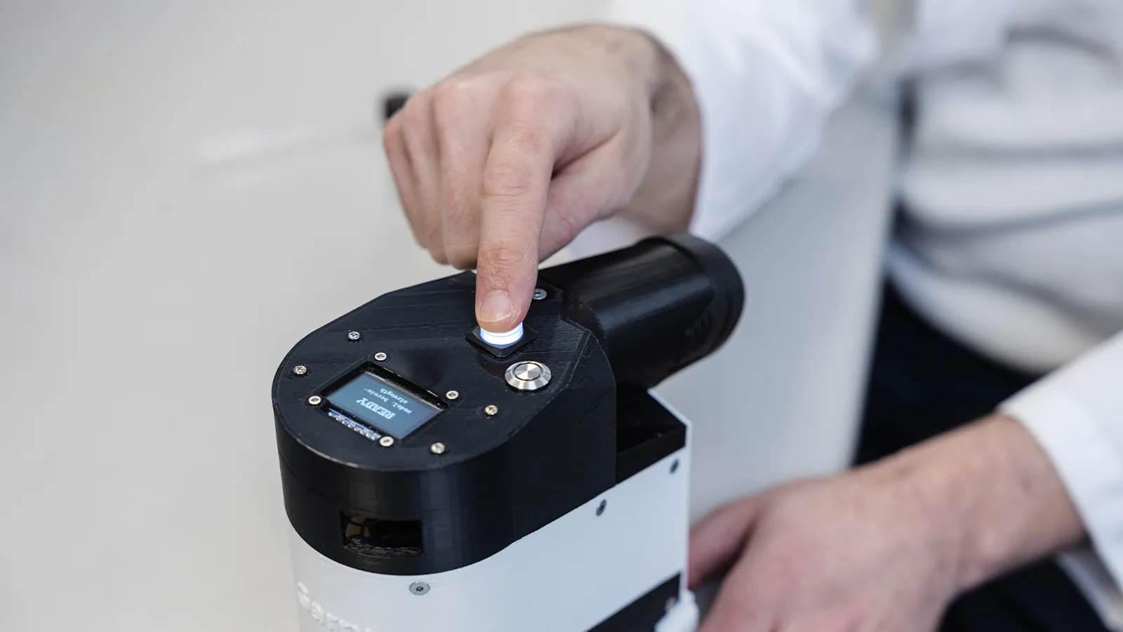 Harm Reduction team member pressing a button on one of their machines