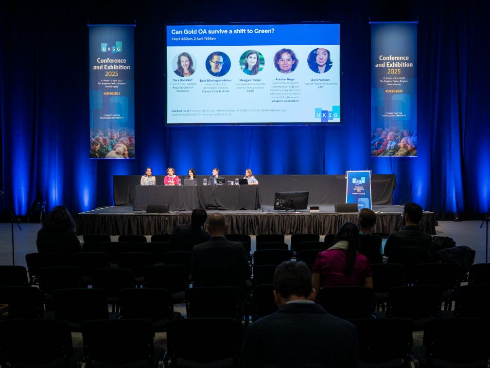 Conference with panel on stage and audience listening