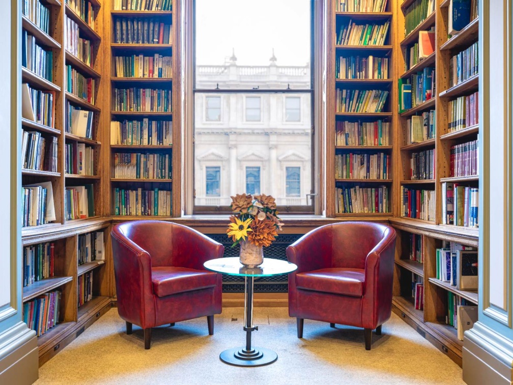 two-chairs-in-library-against-window-and-bookshelf-backdrop two-chairs-in-library-against-window-and-bookshelf-backdrop