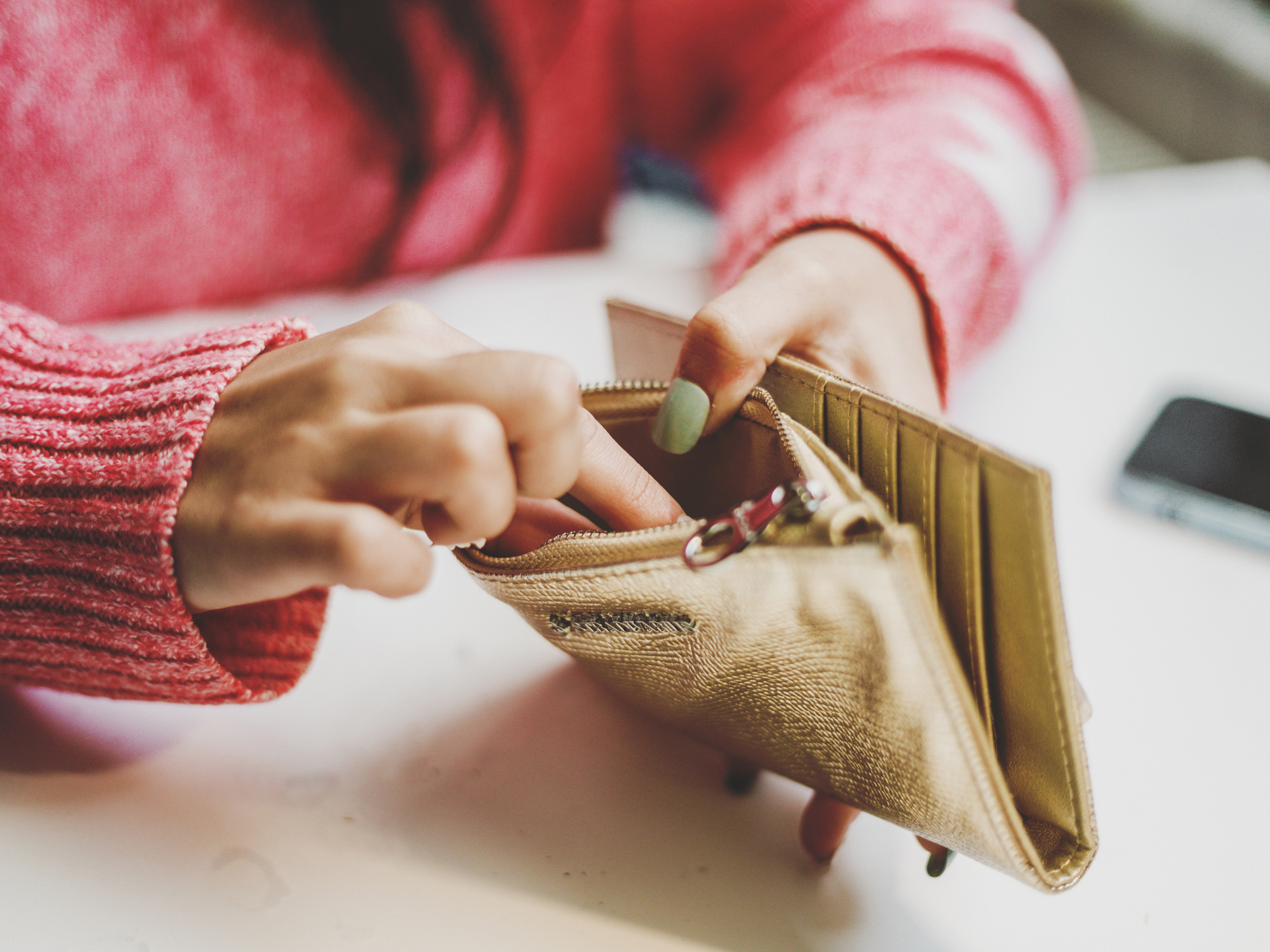 Woman looking in purse for money