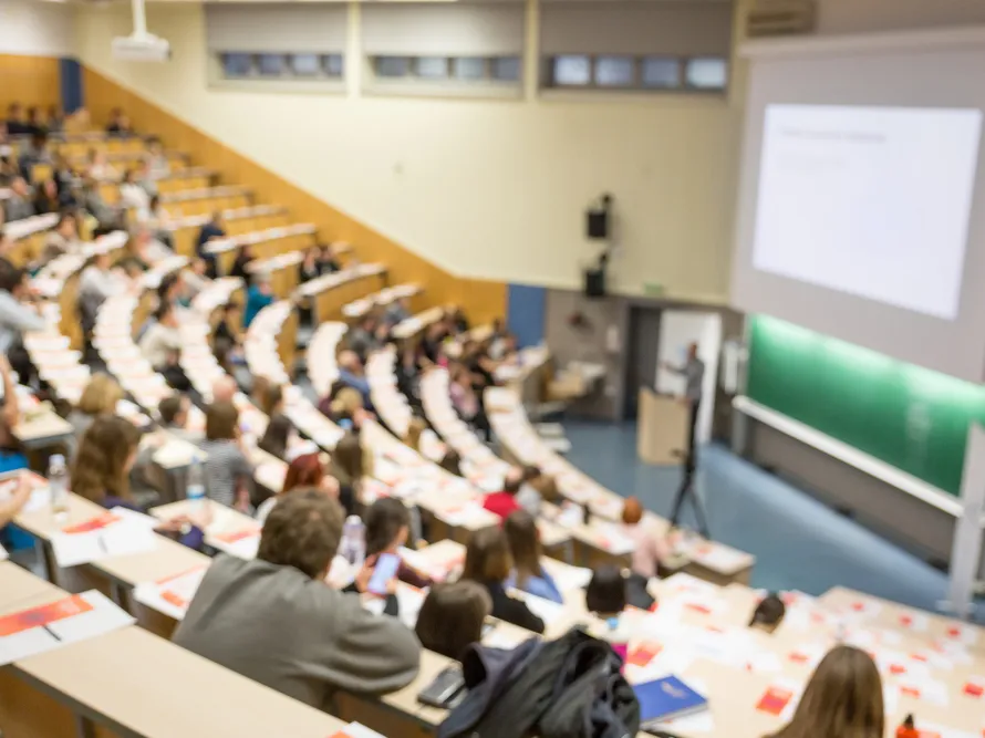 a group of people in a lecture hall