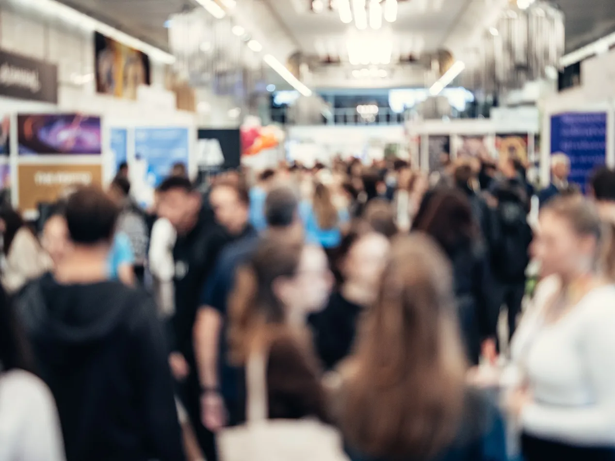 A blurred photograph of a conference setting