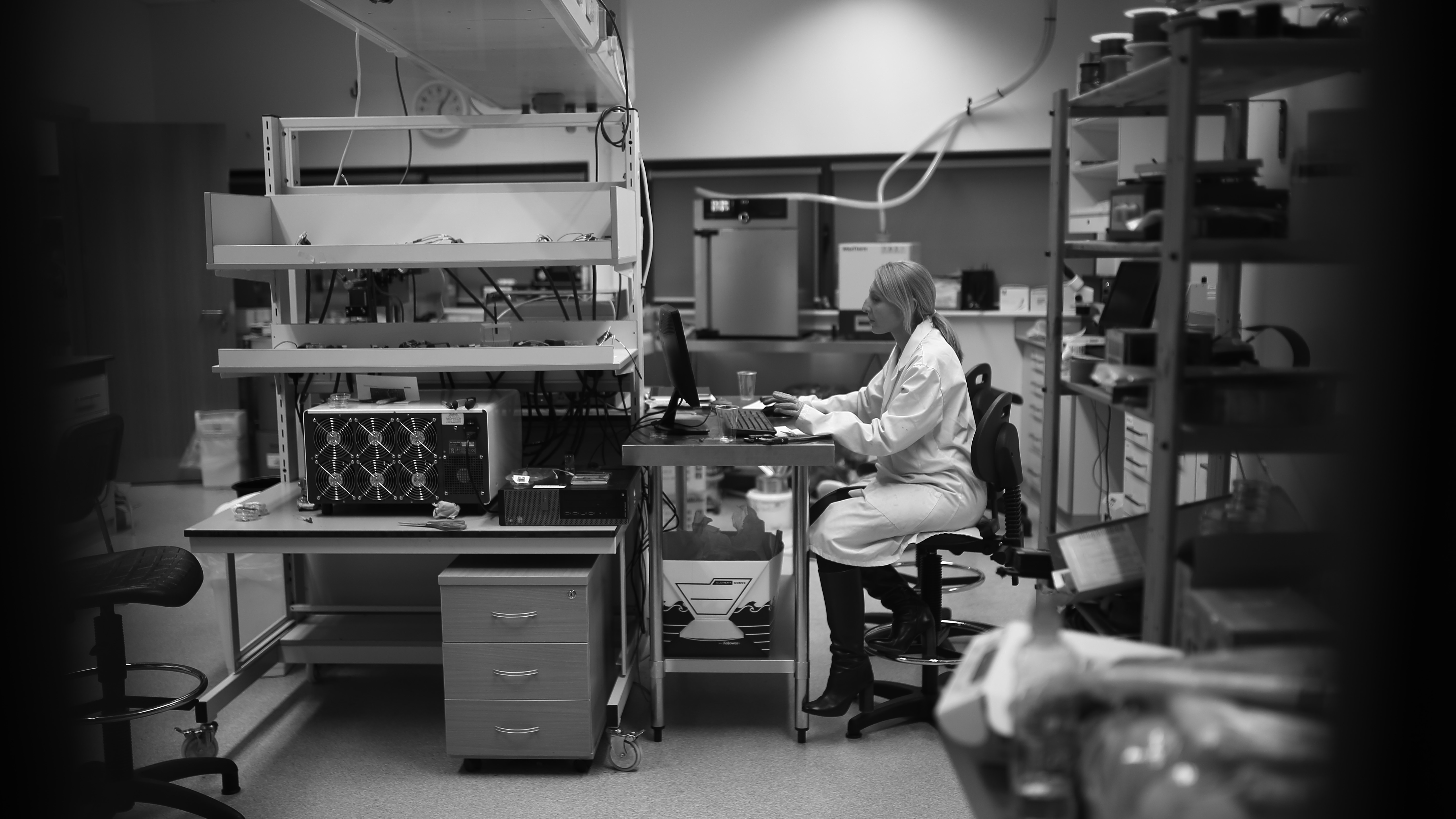 Professor Valeria Nicolosi sitting at a desk in a lab, black and white photo