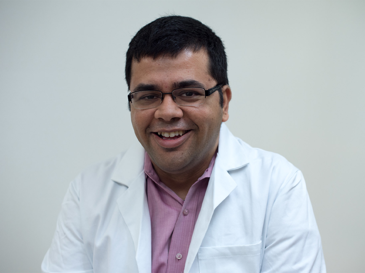 Professor Sarbajit Banerjee in lab coat and glasses