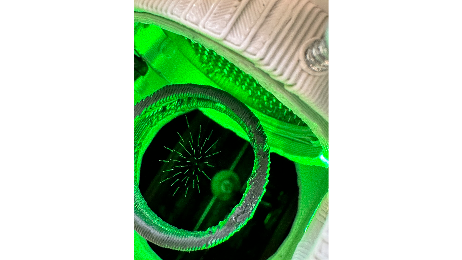 a green light coming out of a machine