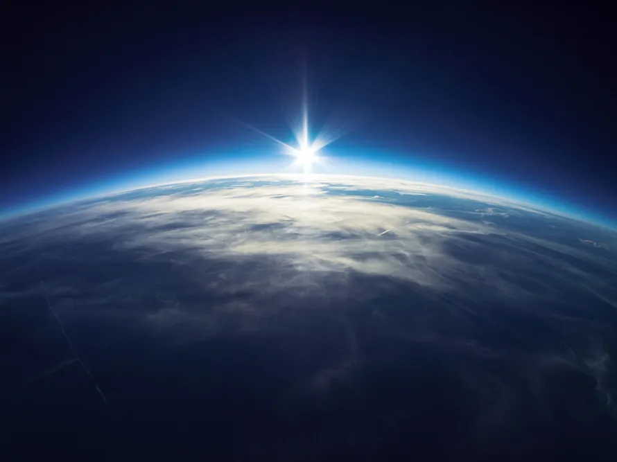 Earth from space with the sun shining on it