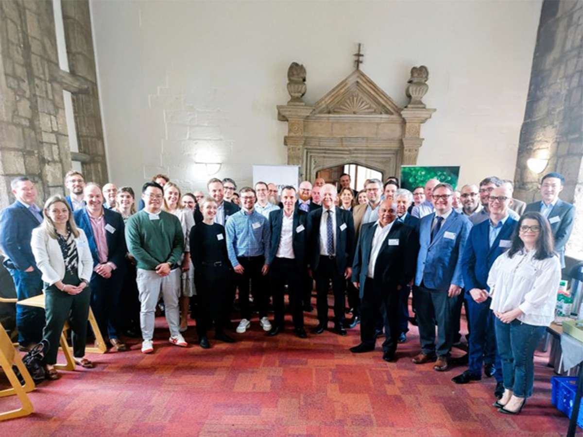 Green Circular Solvent Team standing in large group posing for the camera