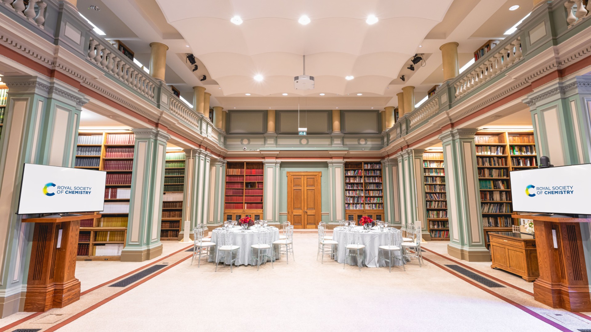 Library with two white tables and screens